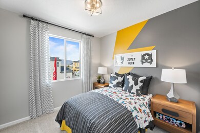 Bedroom featuring light carpet and baseboards
