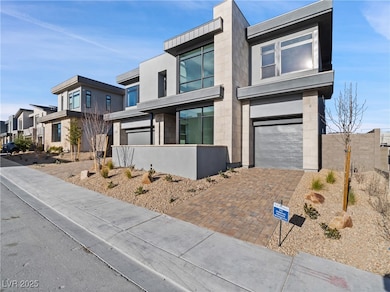Contemporary home featuring decorative driveway, a