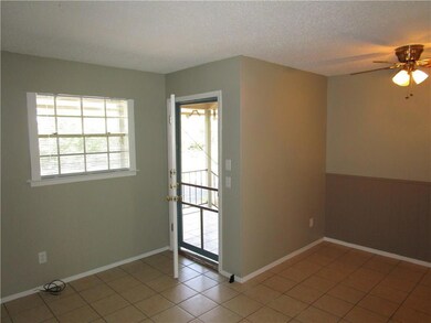 Unfurnished room featuring light tile patterned f