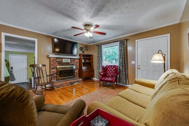 Another angle of the living room looking to the front door. Living room offers beautiful hardwood flooring.