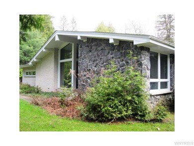 Exterior Front. Side view of brick and stone conte