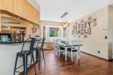 Dining room with baseboards, an inviting chandelie