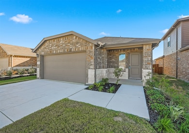 Ranch-style home featuring brick siding, concrete driveway, an attached garage, stone siding, and a shingled roof