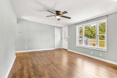 Empty room with ceiling fan and hardwood / wood-st