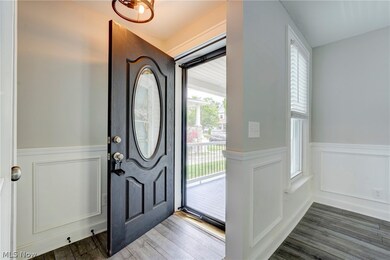 Entryway with dark hardwood / wood-style flooring