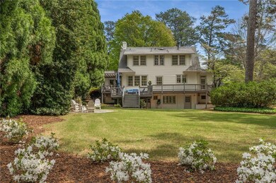Rear view of property featuring long back yard and