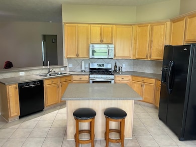 Open Island Kitchen with Breakfast Bar. Refrigerat
