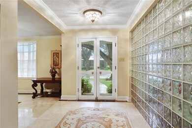 Enter the bright foyer with glass block wall and m