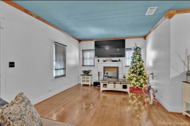 Living room with light wood-type flooring and orna