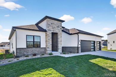 Contemporary home featuring a front yard, an attached garage, roof with shingles, and brick siding