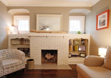 Decorative fireplace and built in shelving.