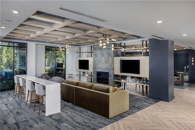 Living room with recessed lighting, a high end fireplace, coffered ceiling, and beam ceiling