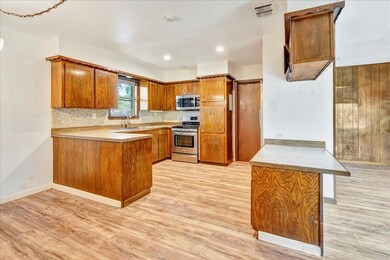 This photo showcases a spacious kitchen. The room