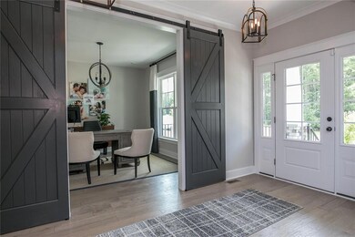 The first floor offers a large dining room with board and batten trim. The office has a closet and barn doors. Hardwoods throughout most of the downstairs. Spacious first floor guest suite. DESIGNER Kitchen with huge quartz island and walk-in pantry.