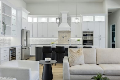 Living area with beverage cooler and light wood-ty