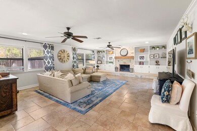 Living area featuring baseboards, a fireplace, vi