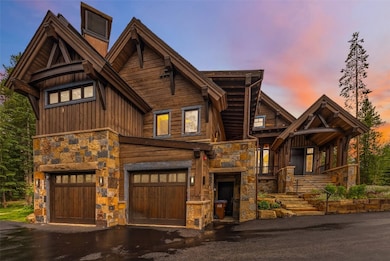 View of front of home with stone siding, an attach