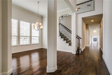 Tall ceiling entry way with wood floor