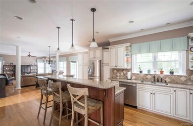 Renovated kitchen with recessed lighting and custom cabinetry. Enjoy breakfast at the raised island.
