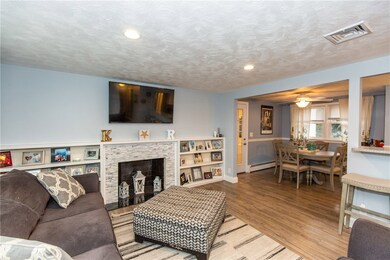Living room with tiled fireplace and built-in shel