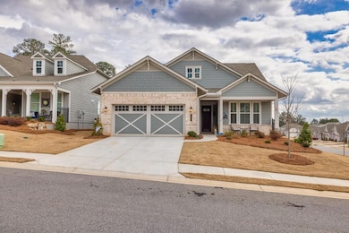 Craftsman house with a porch and a garage