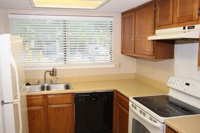 Kitchen featuring white appliances, under cabinet