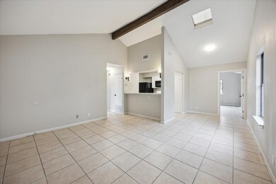 Unfurnished living room with high vaulted ceiling