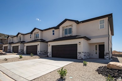 View of front of house with driveway, stucco siding, stone siding, a garage, and a residential view