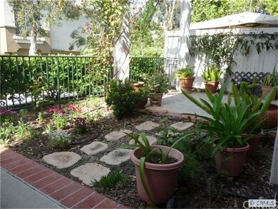 Front yard fenced garden patio with wood patio tre