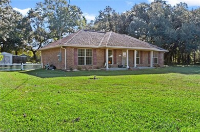 Ranch-style home featuring brick siding, a shingled roof, and a patio area