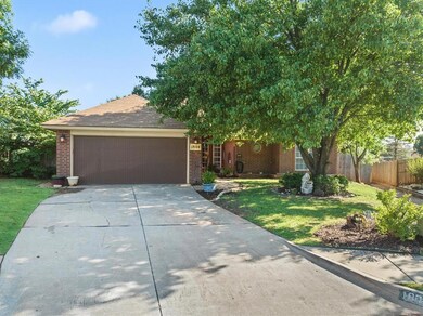View of front of home with a garage and a front la