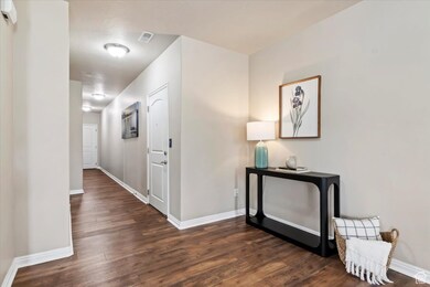 Entry way corridor leading out to garage and main hallway with secured private entrance.