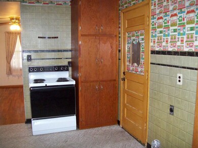 Kitchen with pantry and door to garage