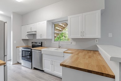 Kitchen featuring butcher block counters, applian