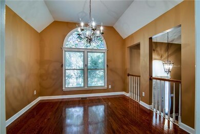 THE GLEAMING HARDWOODS CONTINUE THROUGH THE KITCHEN AND INTO THE FORMAL DINING ROOM. THE VAULTED CEILING, FLOOR TO CEILING WINDOWS, AND RAILS OVERLOOKING THE BALCONY REALLY OPEN UP THIS SPACE.