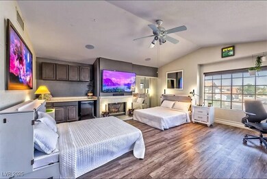 Bedroom featuring wood finished floors, vaulted ce
