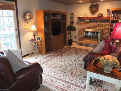 Family room with brick woodburning fireplace and a
