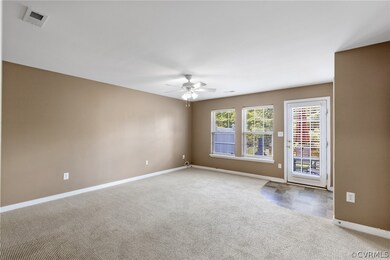 Carpeted spare room with ceiling fan