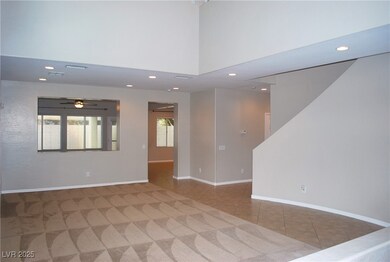 Living room/dining room area with vaulted ceiling