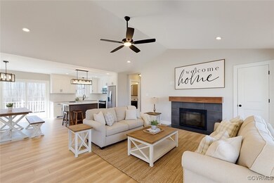 Living room featuring lofted ceiling, light wood-s