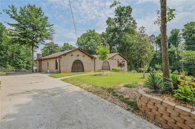 View of front of property with brick siding, a chimney, and concrete driveway