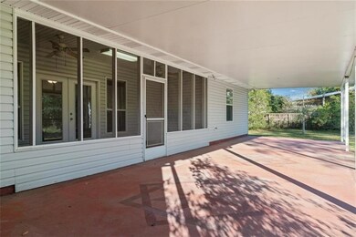 Back patio with a screened in porch