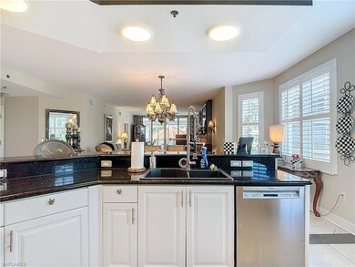 Kitchen with light tile patterned floors, a chande