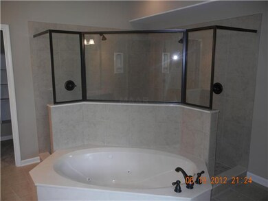 Walk thru tile shower and large whirlpool tub