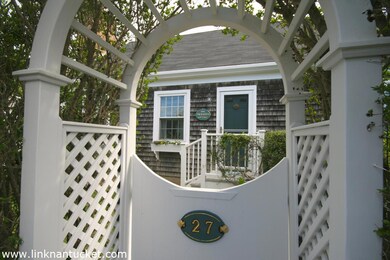 A white gate & arbor welcome you.