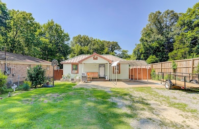 Rear view of property featuring a metal roof, a standing seam roof, and a chimney