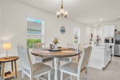 Dining room featuring light tile patterned floors, a chandelier, and recessed lighting