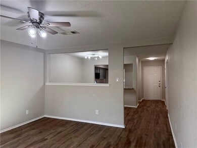 Empty room featuring a textured ceiling, visible v