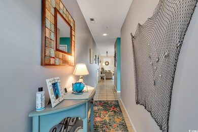 Hallway with light tile patterned floors