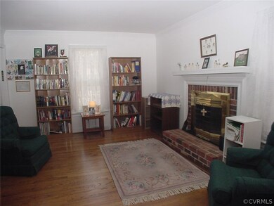 Living room has crown molding & 2 windows